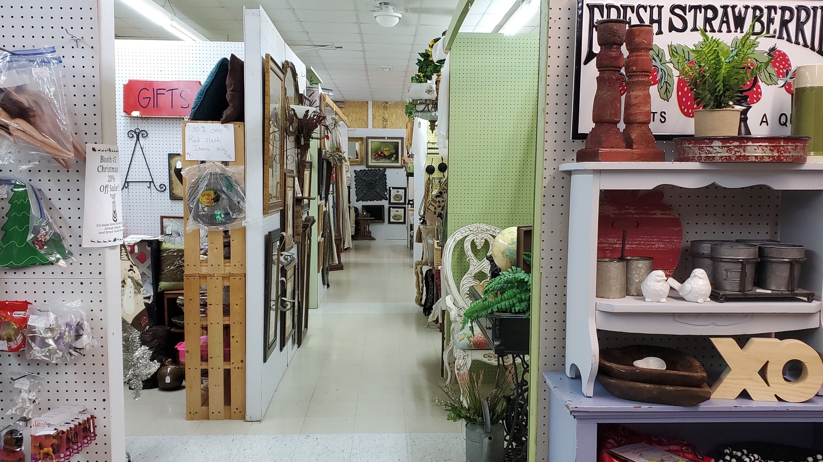 Decor displays and booth aisle inside Rusty Rooster Flea Market in Mountain Home Arkansas