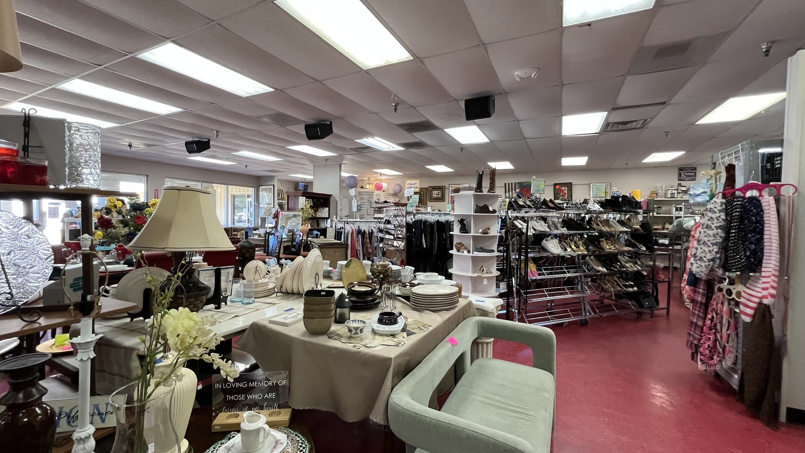 Table displays shoes and clothing inside ReSale Heaven Thrift Store in Gulf Shores
