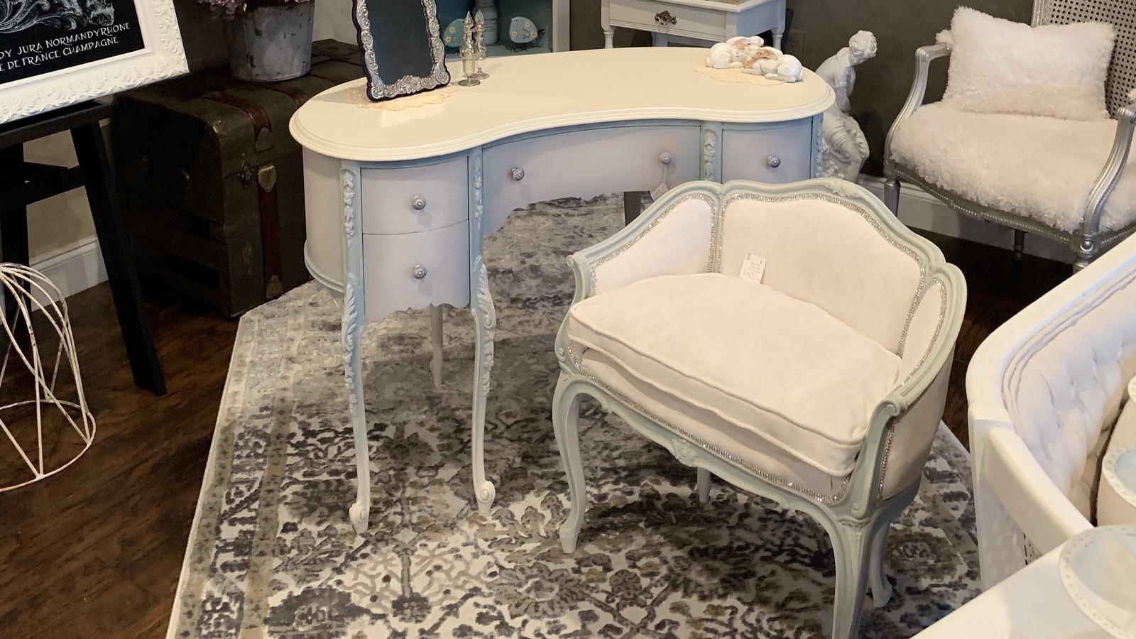 Painted vintage desk and upholstered chair inside Sweet Home Vintage Market in Sebastian Florida