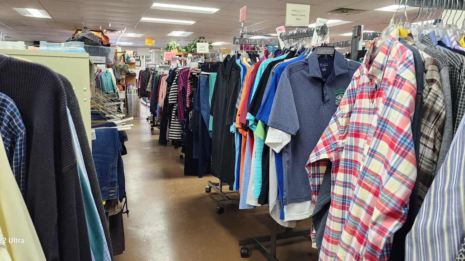 Clothing aisle inside NobleCause resale shop in Noblesville Indiana