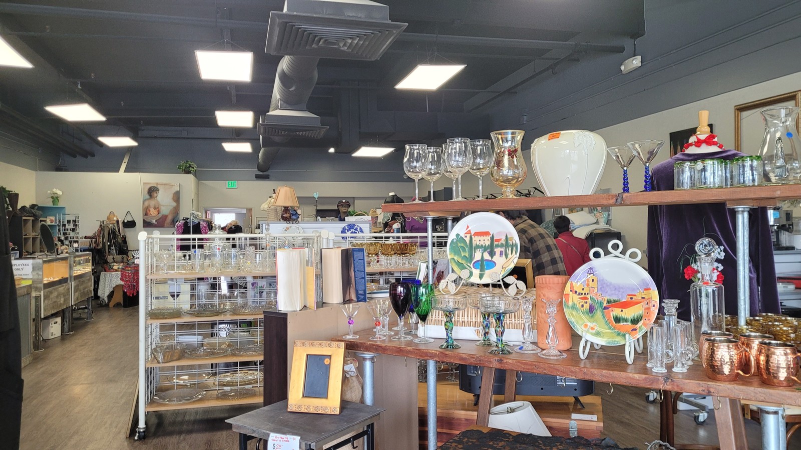 Glassware displays and clothing racks inside Hospice Thrift Shoppes in Pleasant Hill California