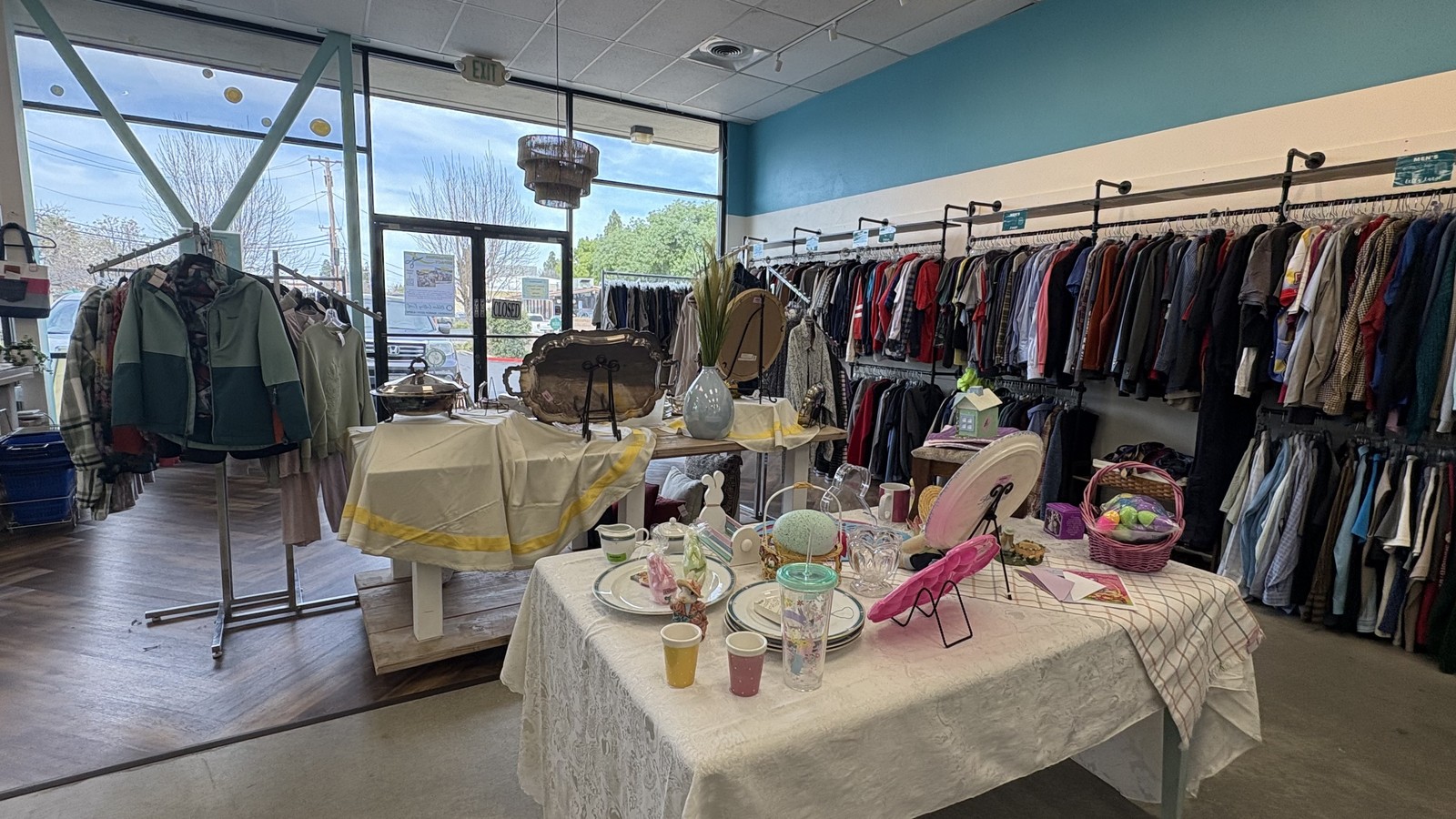 Display tables and clothing racks inside Youth Homes Thrift Shop in Pleasant Hill California