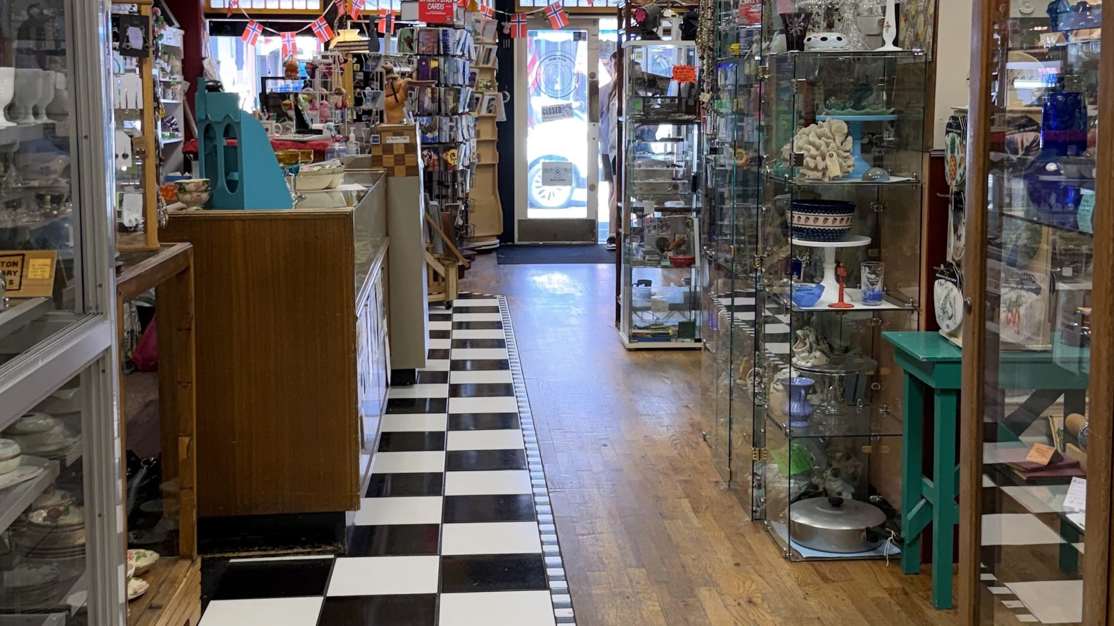 Antique cases and checkerboard flooring inside Cat's Meow in Poulsbo